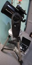 Celestron CPC Series telescope on stand with various accessories including: cased lenses,