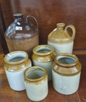 A collection of stoneware items to include: two flagons and four utensil jars. (6) (B.P. 21% + VAT)