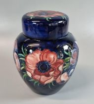 Moorcroft pottery tube lined 'anemone' ginger jar and cover, on a cobalt blue ground. 16cm high