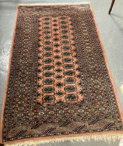 Middle Eastern design salmon ground floral and geometric runner with central repeating tarantula
