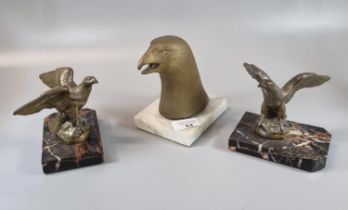 Pair of gilded Eagle ornaments after J Gerard, each on veined marble base, together with an Egyptian