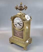 19th century yellow metal mantle clock, having silvered Roman chapter ring, urn finial and French