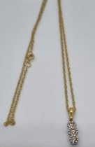 9ct gold three stone diamond drop pendant on 9ct gold chain. 2.5g approx. (B.P. 21% + VAT)