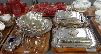 Two trays of silver plate to include: blue glass lined cruet items, toast racks, gravy boats, oval