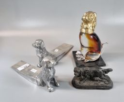 Pair of aluminium door wedges in the form of seated Retrievers, a glass and gilded metal