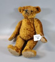 Brown plush teddy bear with jointed body, boot button eyes, hump back