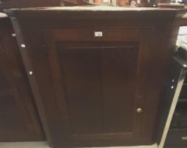 19th century oak single door blind panelled hanging corner cupboard, the interior revealing three