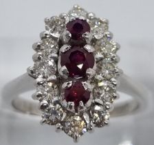 18ct white gold ring of twelve diamonds and three rubies. 7.4g approx. Size N1/2. (B.P. 21% + VAT)