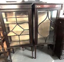 Two similar Edwardian mahogany inlaid single door glazed display cabinets, one with glass