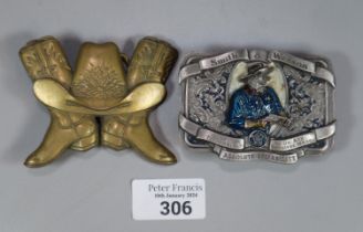 Two American belt buckles, one solid brass in the form of cowboy boots and one Smith and Wesson. (2)