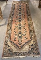 Salmon ground Middle Eastern design runner with repeating lozenge and floral designs. 272x77cm