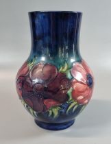 Moorcroft pottery tube lined 'anemone' vase of baluster form. 22cm high approx. Impressed and