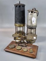 Two traditional brass Miners safety lamps in used condition together with a set of brass postal