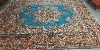20th century large Persian design carpet on a blue, cream and red ground, central floral