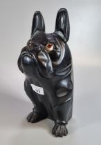 A carved wooden black lacquered French Bulldog shape tobacco jar with hinged lid and glass eyes. (