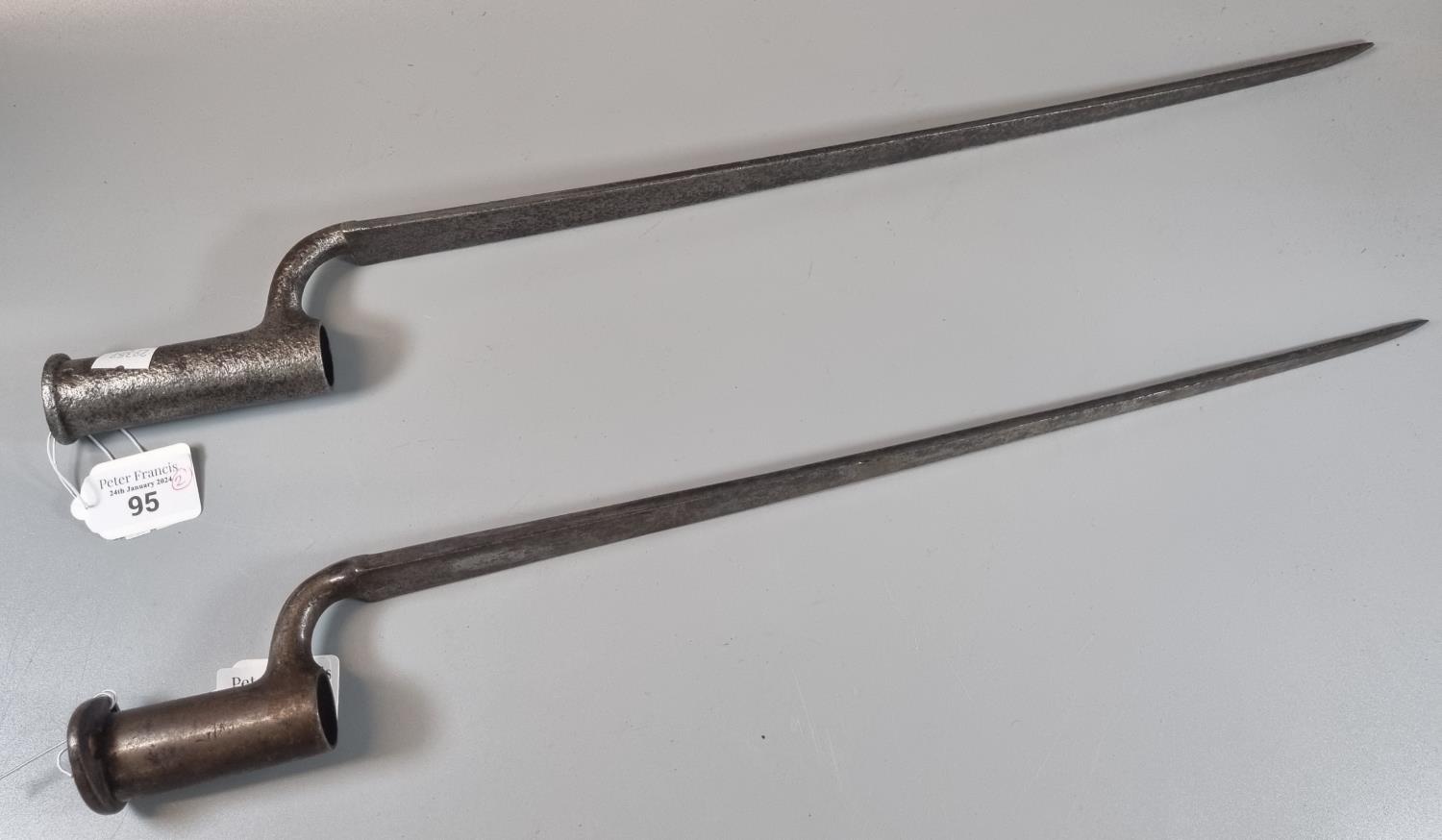 Two similar British 19th century socket bayonets with fluted triangular blades, one in relic