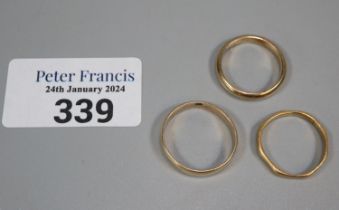 Two 9ct gold wedding bands. 5.3g approx., together with a 22ct gold wedding band. 2.2g approx. (B.P.