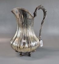 White metal, probably continental pitcher jug standing on four acanthus leaf and cabriole legs