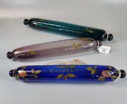 Three Victorian coloured glass rolling pins with hand painted floral and other decoration, one