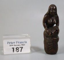 Japanese carved wooden Netsuke in the form of a mermaid curled around a rock. Inset mother of