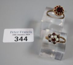 9ct gold garnet flowerhead ring. 2.8g approx. Size O. Together with 9ct gold opal and ruby or garnet