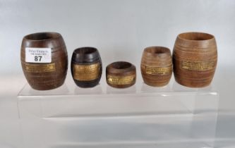 Group of turned wooden miniature barrels as match holders, each made from timber from various famous