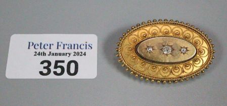 Victorian 15ct gold brooch, of oval form inset with three diamonds. 11.9g approx. (B.P. 21% + VAT)