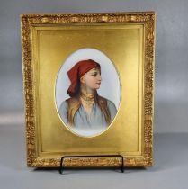 KPM porcelain hand painted plaque depicting an Arab girl, in gilt frame. The plaque 21 x 16cm approx