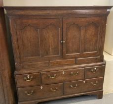 Early 19th century Welsh oak two stage low press cupboard with moulded cornice above inlaid