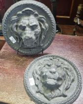Pair of probably moulded lead male lion head plaques with repeating rope twist decoration. (