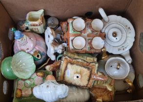 Box of china to include: fireside dog, novelty teapots , egg cruet sets, Cottage Ware items etc. (