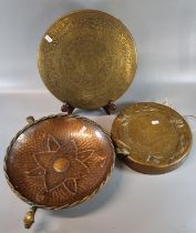 Brass Islamic design dinner gong together with another copper dinner gong decorated with relief