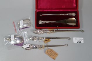 Bag of assorted silver to include: two silver decanter labels one marked 'Dwr Cymru Welsh Water',