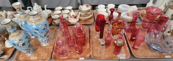 Four trays of glassware to include mainly cranberry glass: jugs, specimen and other vases, cranberry