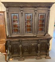 Late 19th century stained oak Flemish design library bookcase with overall carved decoration of lion