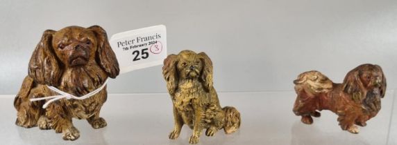 Group of three cold painted bronze Pekinese type dogs in different poses, two small and one large,
