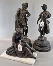 Two spelter figurines, one of a Roman Soldier, both on socle bases together with another spelter