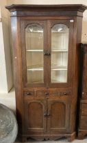 19th century Welsh oak standing double corner cupboard with moulded cornice over arched glazed