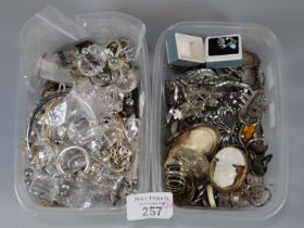 Two plastic tubs of jewellery to include: a large collection of silver and other dress rings,
