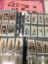 Cigarette cards collection in three albums and loose pages, mostly Players and Wills with a good