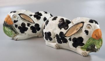 Pair of 19th century Staffordshire Pottery hand painted recumbent rabbits, with black patches,
