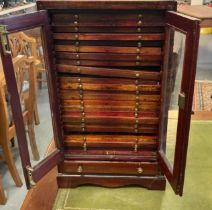 Edwardian mahogany coin collector's cabinet having two glazed doors revealing multiple fitted