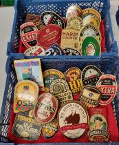 A small crate containing vintage advertising beer pump clips to include: 'Young Tom, Tomos Watkins &