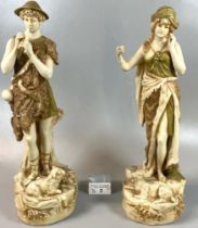 A pair of Royal Dux figures, modelled as a shepherd and a shepherdess with a lamb and a goat at