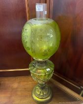 Early 20th Century double oil burner lamp having uranium frosted glass globular shade above an