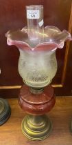 Early 20th Century double oil burner lamp having frosted and cranberry shade above cranberry