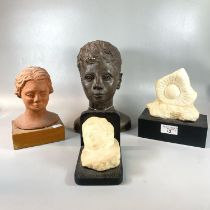 Two moulded busts; one in terracotta on wooden base. Together with a replica fossil on wooden base