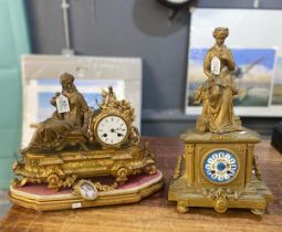 Two 19th century gilt spelter figural mantle clocks, both with ceramic Roman faces, one on