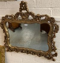 19th century style gilded mirror, the frame pierced with relief floral and folate designs. 91x85cm