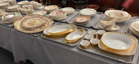 Two trays of Royal Worcester porcelain gold finish dinner ware items, tureens etc. together with